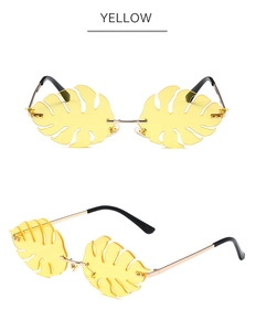 Detailed view of yellow monstera leaf shaped rimless sunglasses with metal temples
