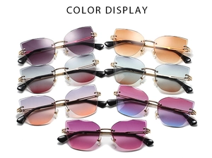Detailed color display of rimless cat-eye sunglasses with gradient lenses and gold metal stems