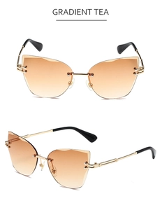 Close-up of rimless cat-eye sunglasses with gradient tea lenses and golden metal temples