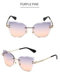Detail view of purple pink rimless cat eye sunglasses with gold metal frame