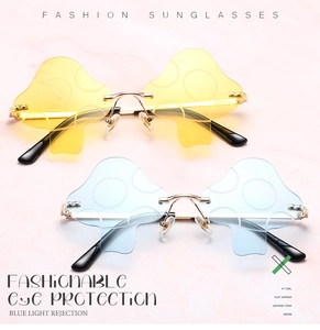 Detail of mushroom shaped rimless sunglasses with gold metal frames and anti-blue light lenses