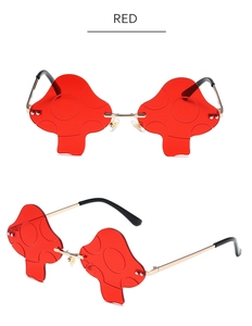 Detail of red mushroom-shaped sunglasses with dot texture and golden metal frames