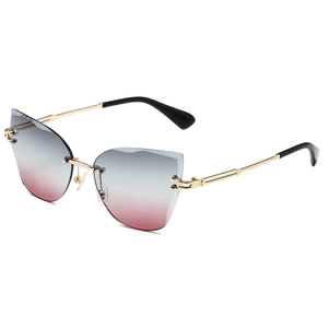 Frameless cat-eye sunglasses with gradient grey-pink lenses and golden metal frames