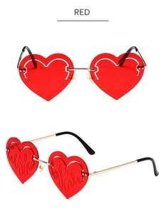 Detail of red heart-shaped flame sunglasses with gold metal frame and cutout lens effect