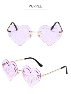 Detail view of heart-shaped purple flame sunglasses with rimless lenses and gold metal temples