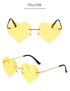 Detailed view of yellow heart-shaped flame sunglasses with rimless metal frame