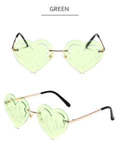 Detail of green heart flame-shaped lenses and golden metal frames on sunglasses