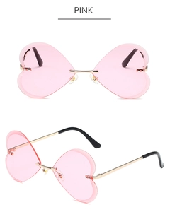 Gros plan de lunettes de soleil coeur rose sans monture avec branches en métal doré chic