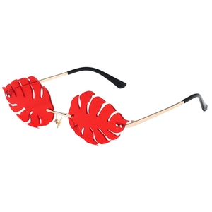 Leaf-shaped sunglasses with vibrant red tropical leaf lenses and golden metal frames