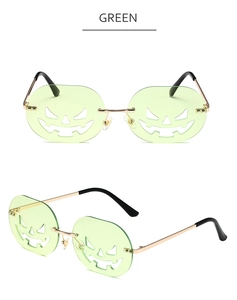 Close-up of green pumpkin-shaped lens and gold metal frame of Halloween sunglasses