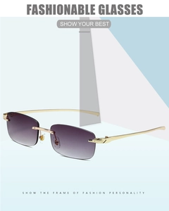 Close-up of golden leopard head detail on rimless sunglasses with purple gradient lenses