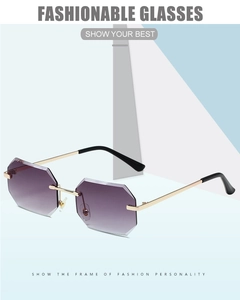 Detail of rimless octagonal sunglasses with purple gradient lenses and gold metal frames