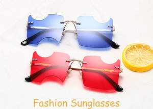 Detail view of meteor-inspired rimless sunglasses with blue and red lenses on marble