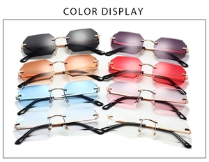 Multiple colors of rimless geometric sunglasses with gold metal frames in a display