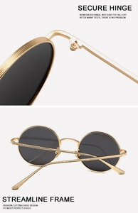 Detailed view of secure metal hinges and streamlined frame of round punk sunglasses