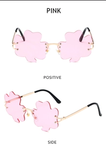 Detailed views of pink clover-shaped rimless sunglasses with gold metal frame