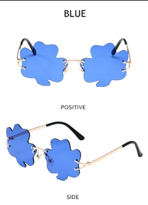 Detail view of blue clover-shaped rimless sunglasses with gold metal frame