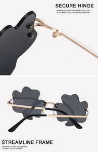 Detail of secure metal hinges and stylish rimless wavy lenses on clover sunglasses