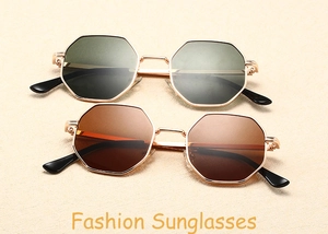 Detail of octagonal metal sunglasses with rose gold frames and dark lenses