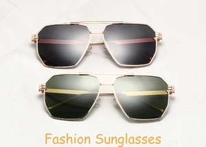 Flat lay of aviator sunglasses with gold frames and gradient lenses on marble surface