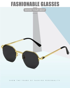 Detail of octagonal semi-rimless sunglasses with gold metal frame and black lenses