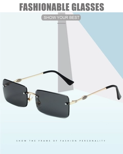 Detail of rimless rectangle sunglasses showing gold metal hinges and engraved temples