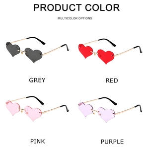 Detail view of heart-shaped rimless sunglasses in grey, red, pink, and purple colors