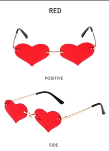 Detailed front and side view of rimless heart-shaped red sunglasses with gold metal arms