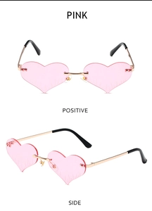 Close-up of heart-shaped rimless pink sunglasses with gold metal temples and side view