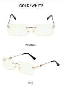 Detail view of gold rimless square sunglasses with vintage engravings and white lenses