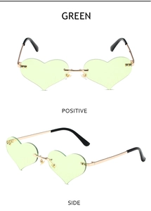 Close-up of green heart-shaped rimless sunglasses with gold metal frame and double bridge