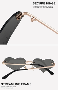 Macro detail of rimless heart sunglasses with gold metal hinges and flame-cut lens edges