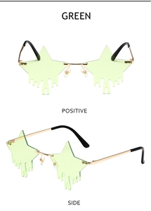 Detail view of star-shaped rimless sunglasses with green dripping lens and gold metal frame