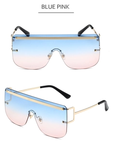 Detail of oversized rimless flat top sunglasses with blue-pink gradient lenses and gold trim