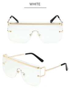 Close-up of oversized transparent eyewear with gold metal frame and black ear tips