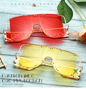 Detail of oversized punk sunglasses with rivet accents and blue light protection