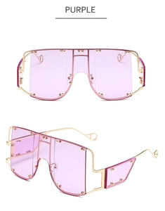 Detail of oversized purple lenses with gold stud rivets and slim metallic frames