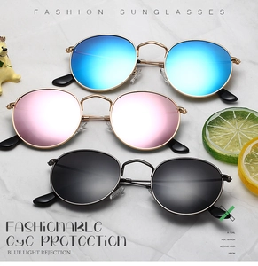 Close-up of vintage round metal sunglasses in blue, pink, and black polarized lenses
