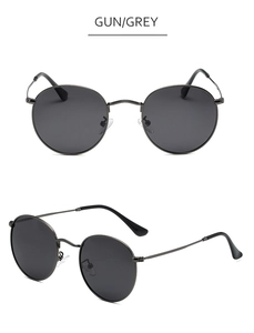 Macro shot of gunmetal retro round frame sunglasses with grey lenses and metal temples