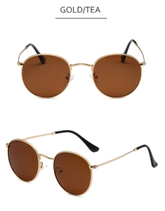 Detail view of round gold metal frame sunglasses with polarized tea brown lenses