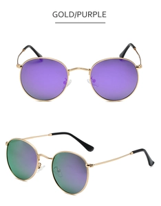 Detail of round gold metal sunglasses with purple polarized lenses and black temple tips