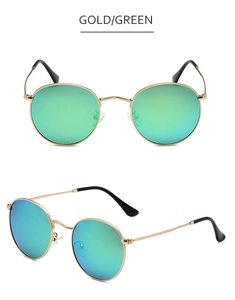 Detail view of round vintage metal sunglasses with gold frame and green polarized lenses