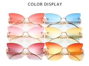 Detailed view of butterfly-shaped rimless sunglasses in six vibrant gradient lens colors