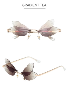 Détail de lunettes de soleil ailes de libellule avec verres dégradés et branches dorées