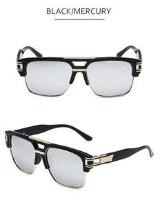 Close-up of black retro sunglasses with silver mirror lenses and gold bridge detail
