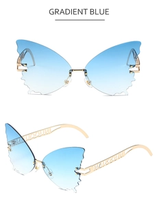 Detail view of butterfly shaped sunglasses with gradient blue lenses and gold metal frame