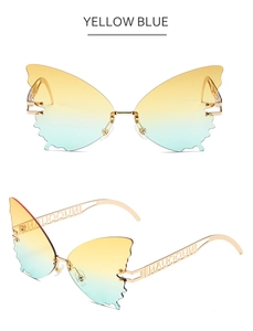 Detail of butterfly sunglasses with yellow blue gradient lenses and gold metal temples