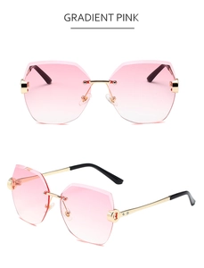 Details von randloser Sonnenbrille mit rosa Verlaufsgläsern und goldenen Metallbügeln