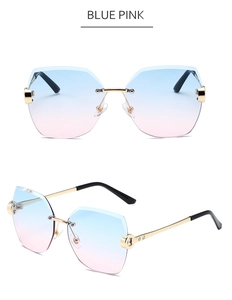 Details einer randlosen Sonnenbrille mit blau-rosa Farbverlauf und goldenen Metallbügeln