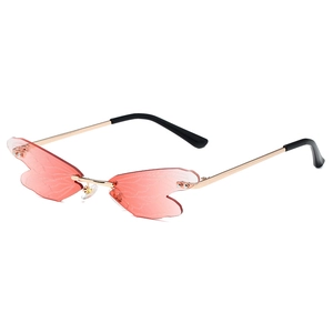 Frameless dragonfly wing sunglasses with pink gradient lenses and gold metal temples